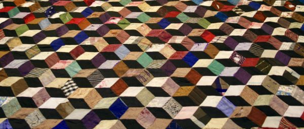 Detail of patchwork quilt with tumbling blocks design